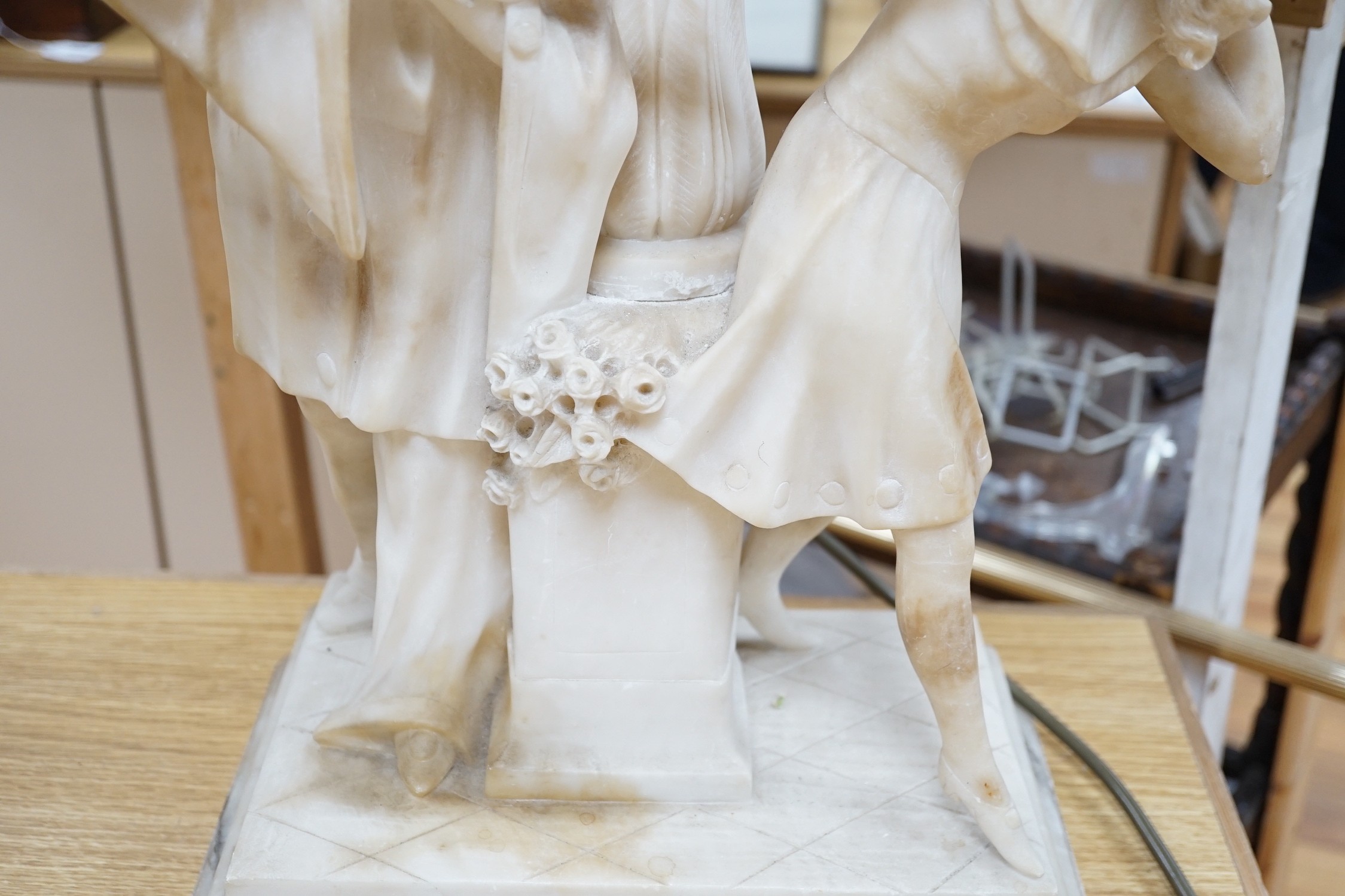 A 1920's carved alabaster clown group figure lamp. 85cm tall